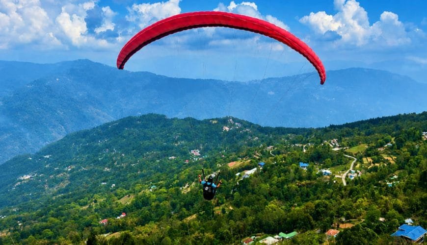 Tandem paragliding above the green hills of South Sikkim