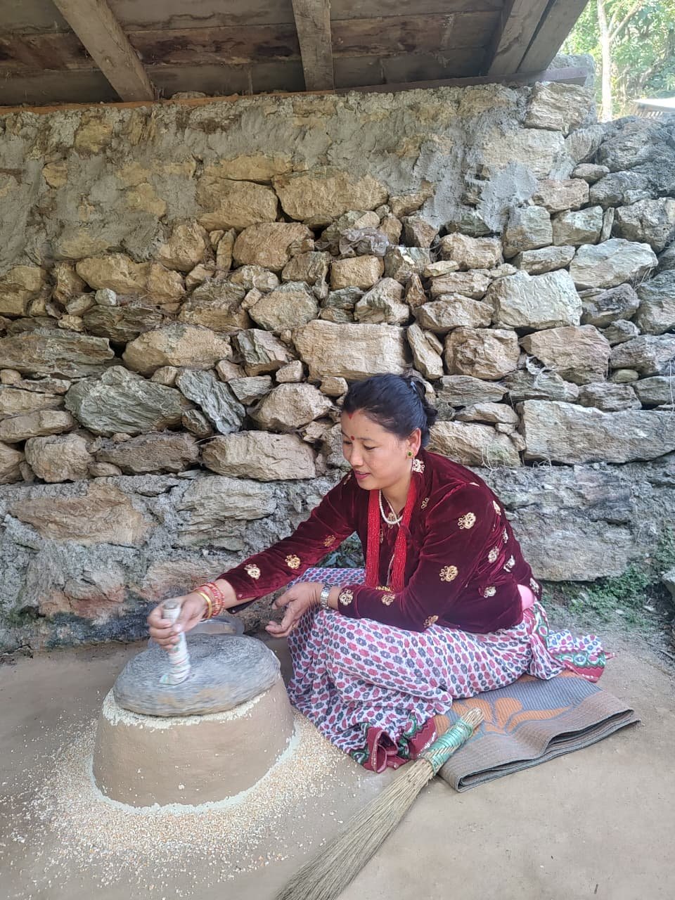 Traditional grain milling demonstration in rural Sikkim
